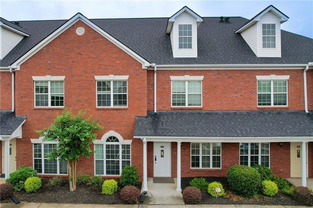 530 Highland Station Drive, Unit 2003 Suwanee, GA 30024 - Photo 1 of 6 a front view of a house with yard and green space
