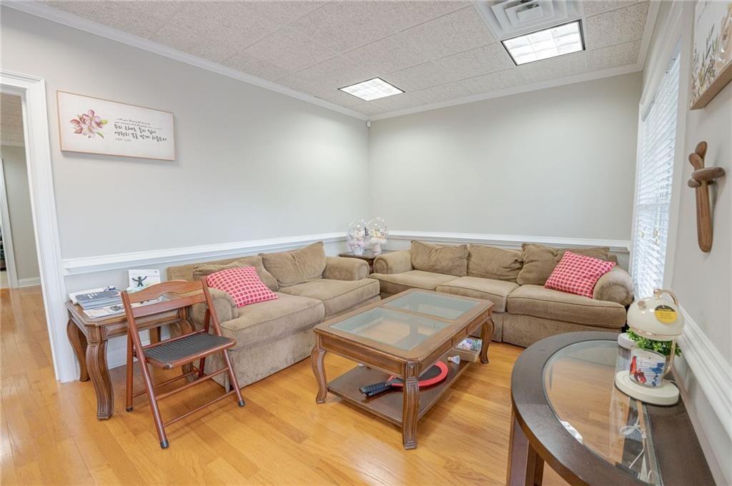 530 Highland Station Drive, Unit 2003 Suwanee, GA 30024 - Photo 2 of 6 a living room with furniture and a wooden floor