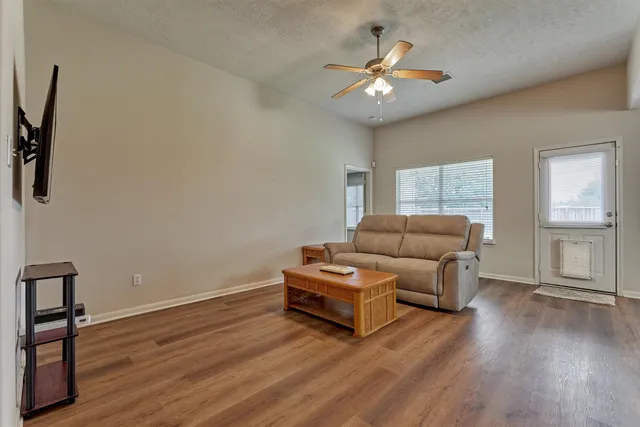 a living room with furniture and a chandelier