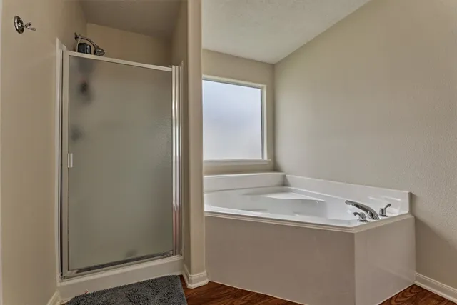 a bathroom with a bathtub and shower
