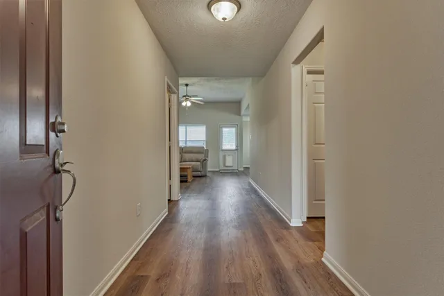 a view of a room with wooden floor