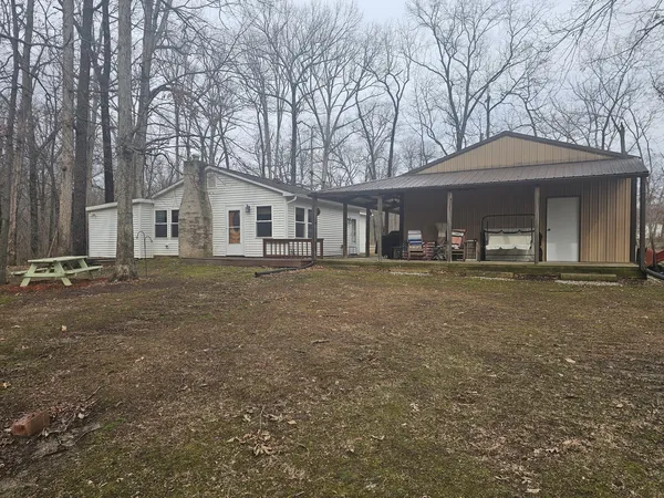 a front view of house with yard and trees