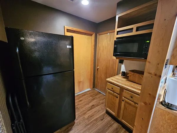 a kitchen with a refrigerator and a stove