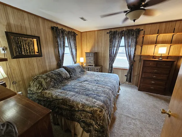 a bedroom with a bed and a dresser