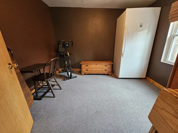 a view of a room with furniture and a window