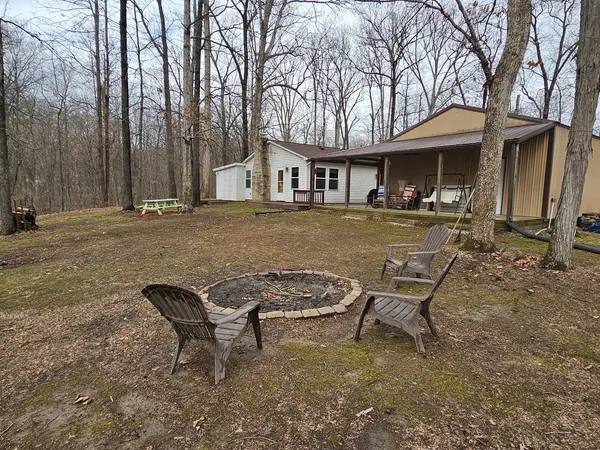 a backyard of a house with table and chairs