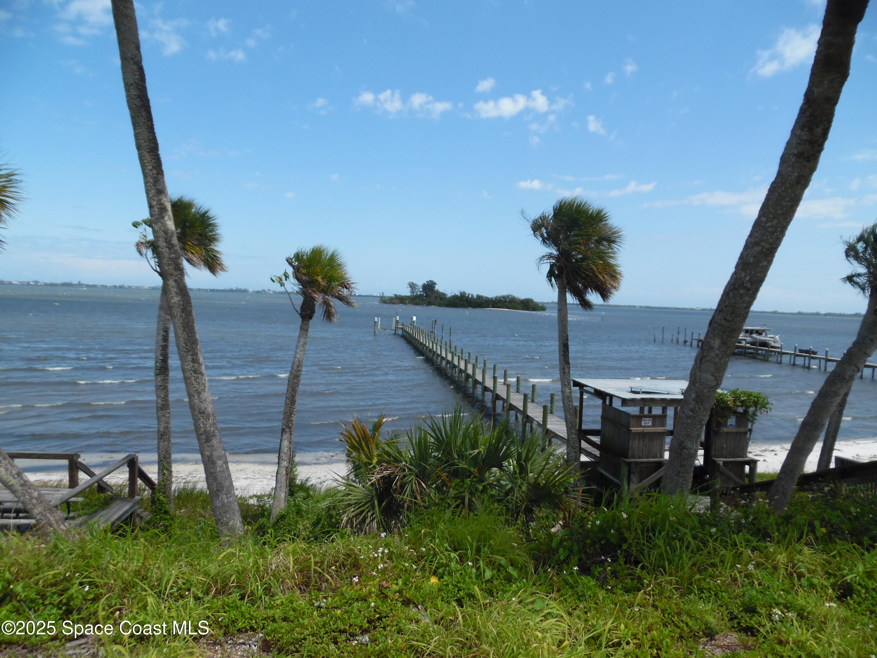 7492 Highway 1, Unit CODE Micco, FL 32976 - Photo 6 of 13 a view of a balcony and floor to ceiling windows