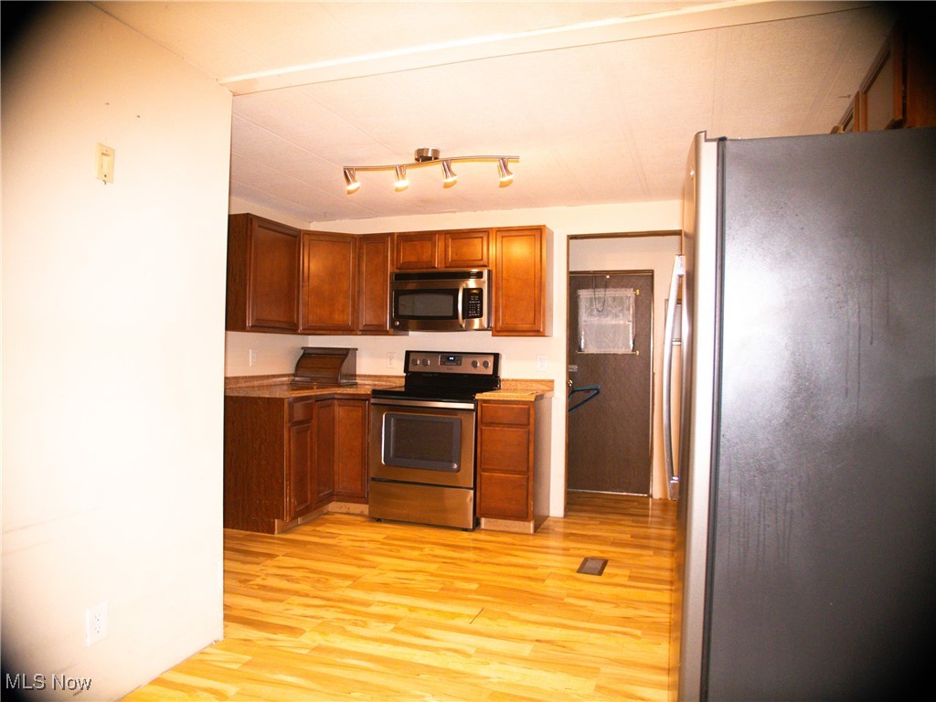332 Max Road Lodi, OH 44254 - Photo 19 of 22 Kitchen featuring stainless steel appliances and light wood-type flooring