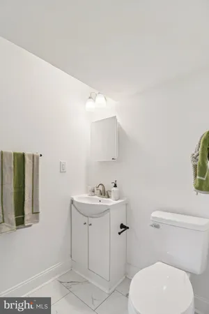 a white toilet sitting next to a bathroom sink