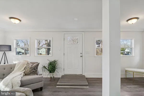 a living room with furniture and view of kitchen