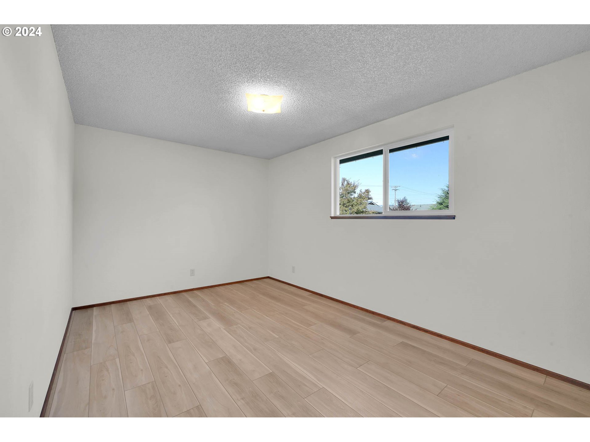 5215 G Street Springfield, OR 97478 - Photo 17 of 35 a view of an empty room with wooden floor