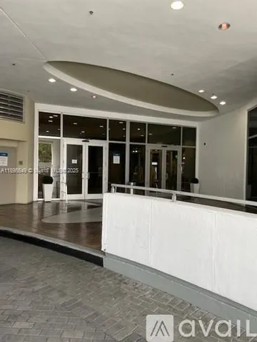 a large white kitchen with a large window