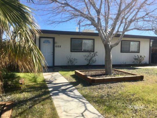1028 Mayo Street Ridgecrest, CA 93555 - Photo 1 of 25 a front view of a house with garden