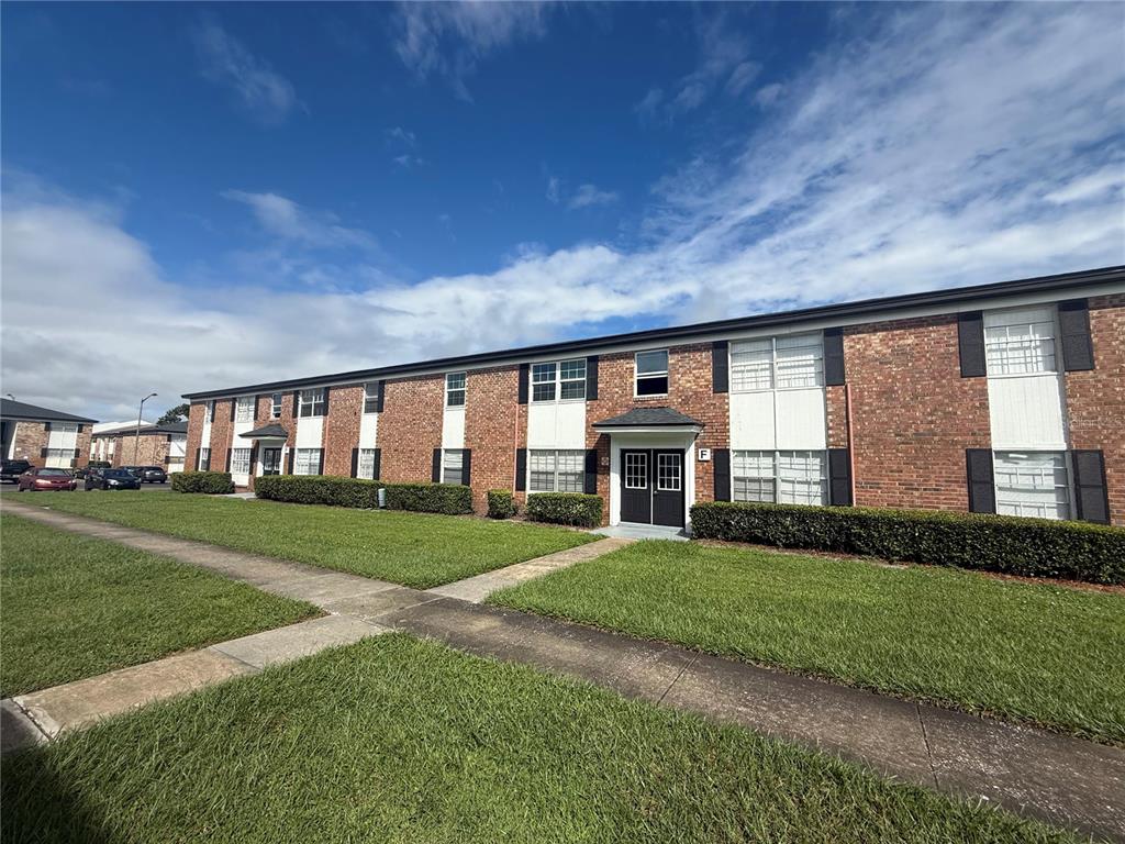 5325 Curry Ford Road, Unit 202 Orlando, FL 32812 - Photo 1 of 1 a front view of a house with a big yard and potted plants