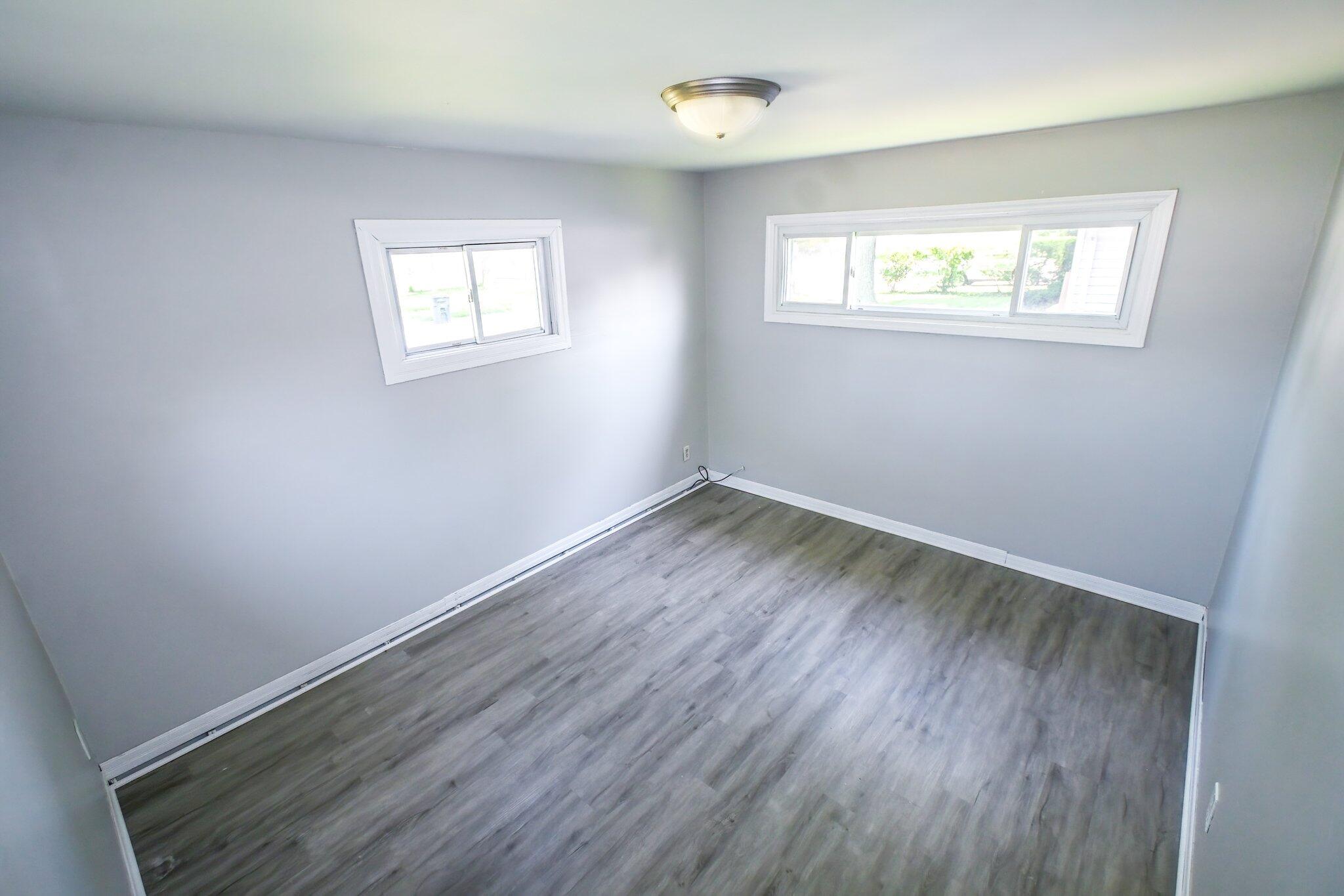 7828 Chestnut Avenue Hammond, IN 46324 - Photo 14 of 23 a room with wooden floor and windows