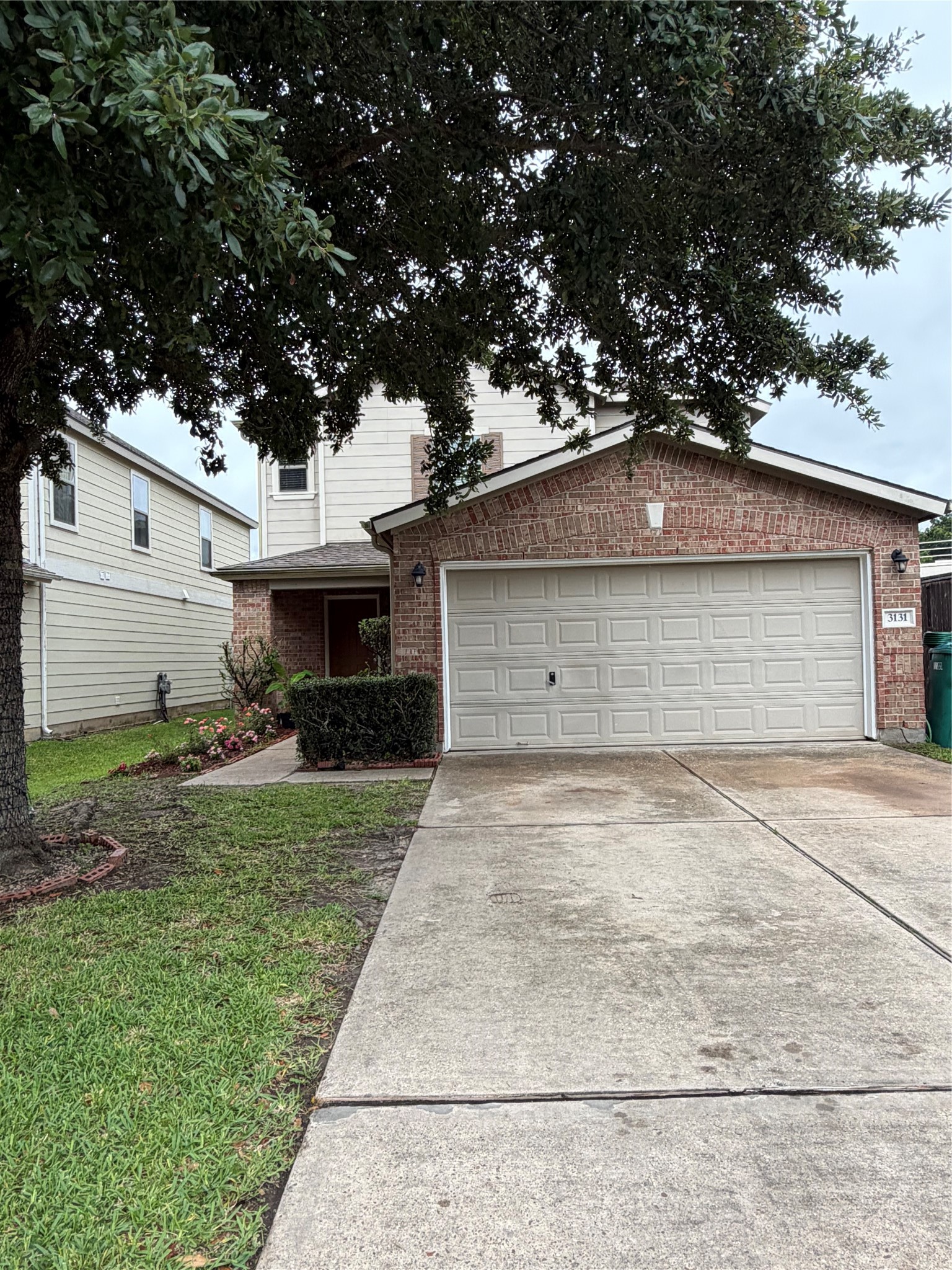 3131 Peachstone Place Spring, TX 77389 - Photo 6 of 20 a front view of a house with a garden and trees