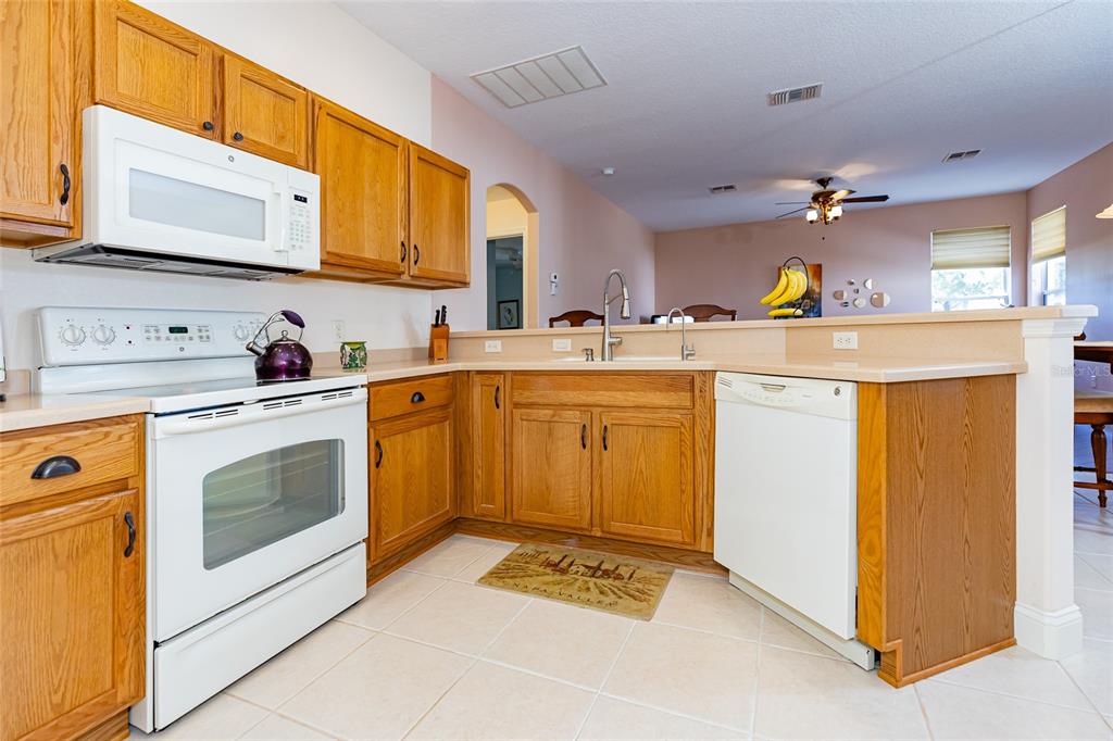 15788 Southwest 11th Terrace Road Ocala, FL 34473 - Photo 15 of 59 a kitchen with a sink stove and cabinets