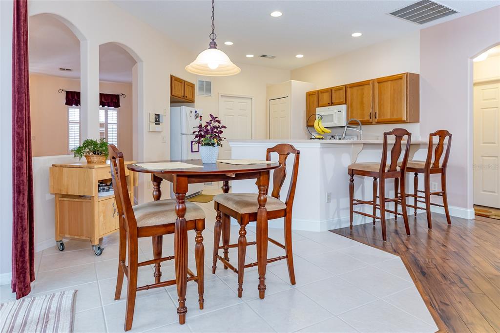 15788 Southwest 11th Terrace Road Ocala, FL 34473 - Photo 17 of 59 a view of a dining room with furniture and wooden floor