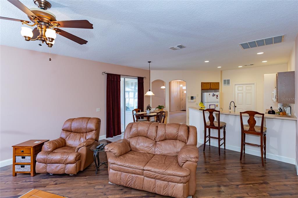15788 Southwest 11th Terrace Road Ocala, FL 34473 - Photo 19 of 59 a living room with furniture kitchen view and a chandelier