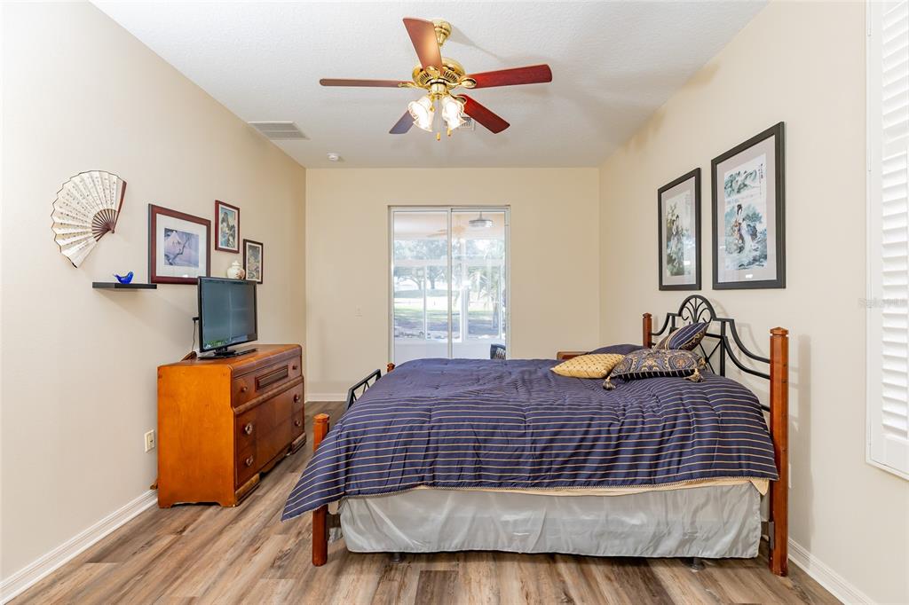 15788 Southwest 11th Terrace Road Ocala, FL 34473 - Photo 21 of 59 a bedroom with a bed and dresser with wooden floor