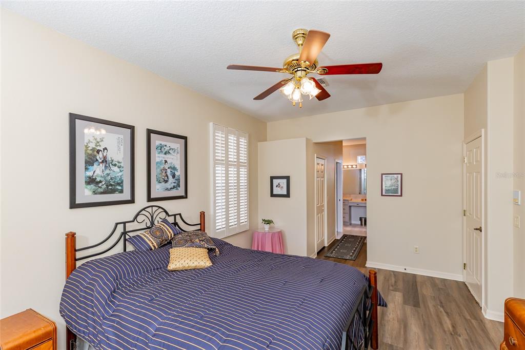 15788 Southwest 11th Terrace Road Ocala, FL 34473 - Photo 22 of 59 a bedroom with a bed and wooden floor