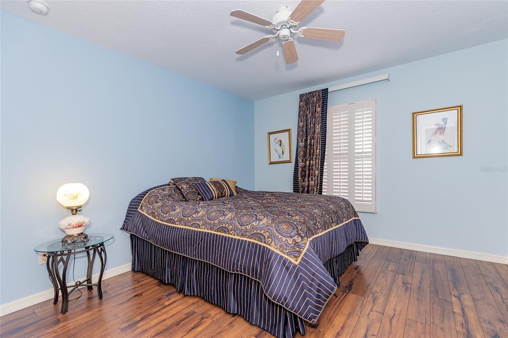 15788 Southwest 11th Terrace Road Ocala, FL 34473 - Photo 28 of 59 a bedroom with a bed and wooden floor