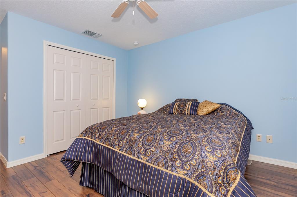 15788 Southwest 11th Terrace Road Ocala, FL 34473 - Photo 29 of 59 a bedroom with a bed and wooden floor