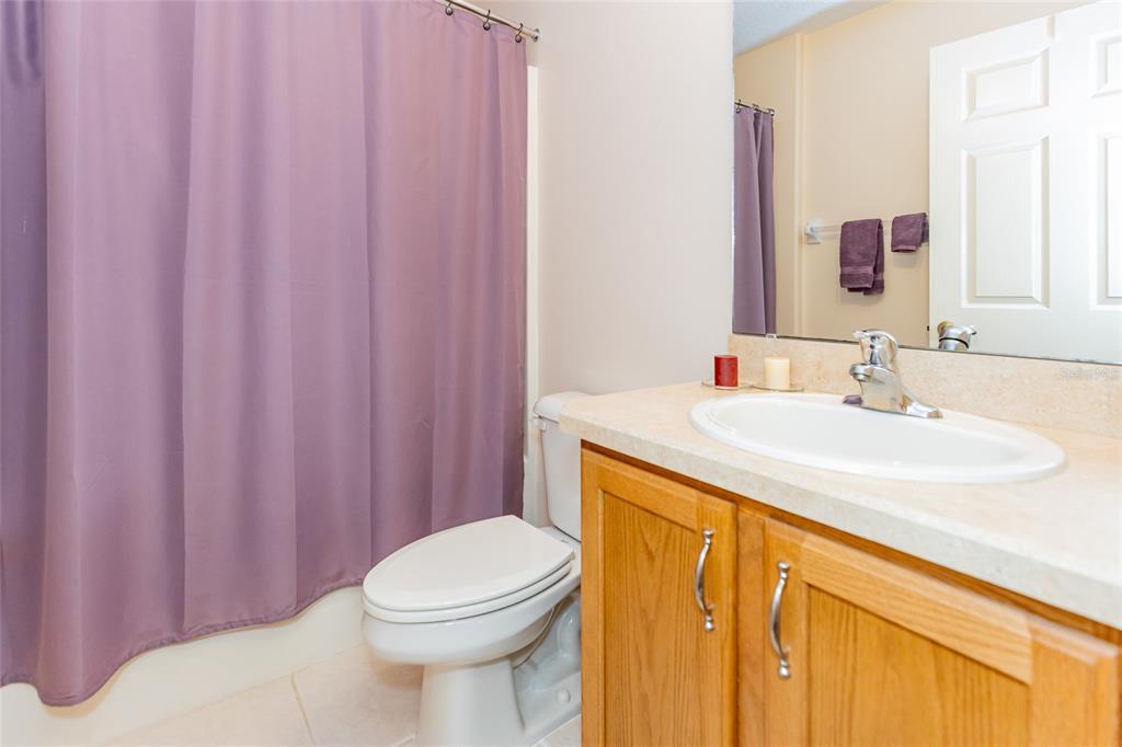 15788 Southwest 11th Terrace Road Ocala, FL 34473 - Photo 31 of 59 a bathroom with a sink a toilet and shower curtain