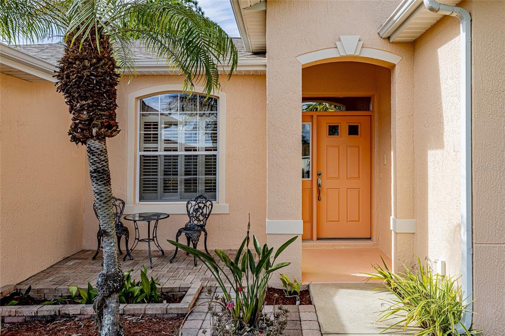15788 Southwest 11th Terrace Road Ocala, FL 34473 - Photo 7 of 59 a front view of a house with outdoor seating and a yard