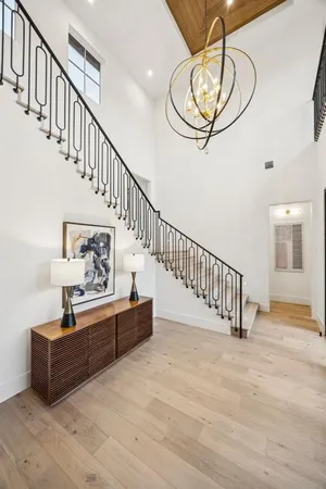 a view of entryway and hall with wooden floor
