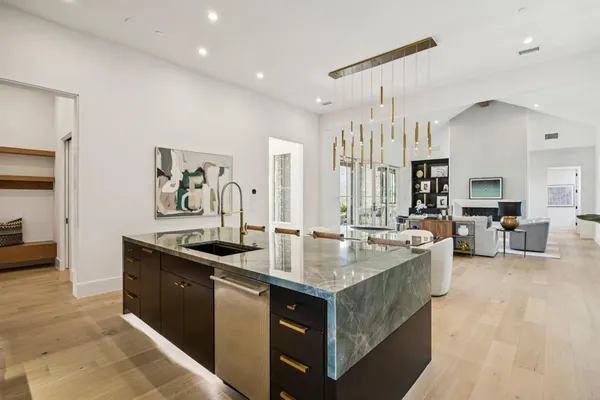 a kitchen with counter top space a sink cabinets and appliances
