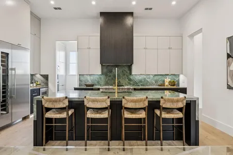 a kitchen with a table chairs stove and cabinets