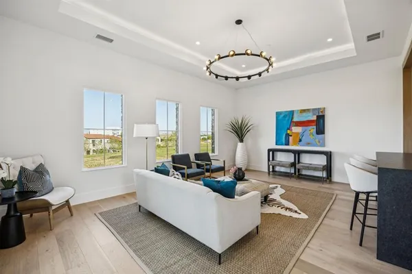 a living room with furniture a bed and a chandelier