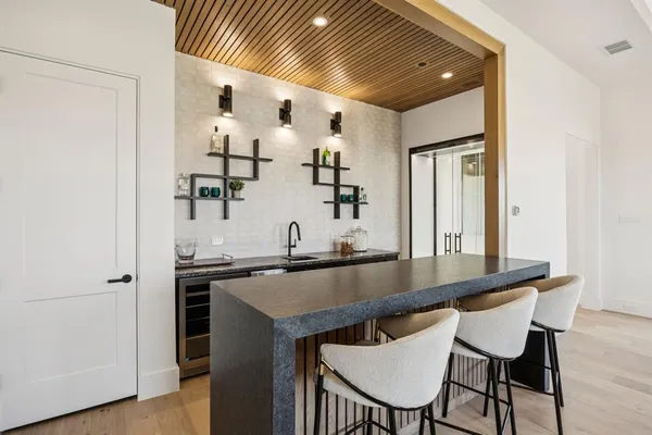 a kitchen with kitchen island a table and chairs in it