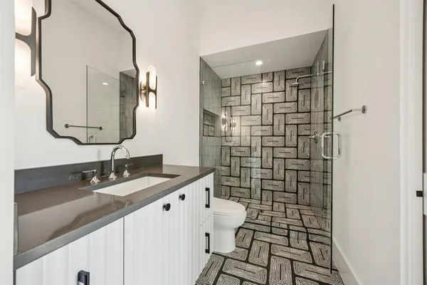 a bathroom with a shower and a sink