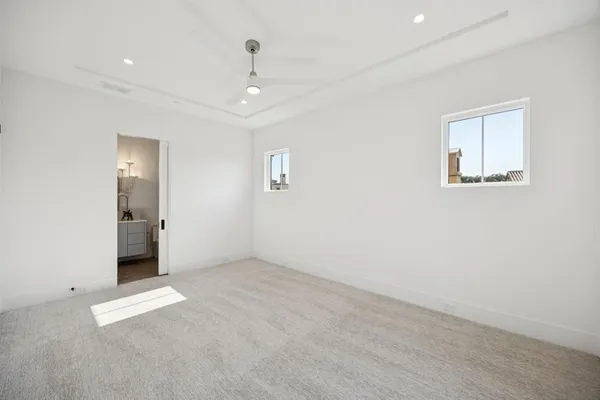 an empty room with windows and closet