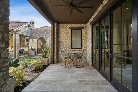 a view of a porch with a table and chairs