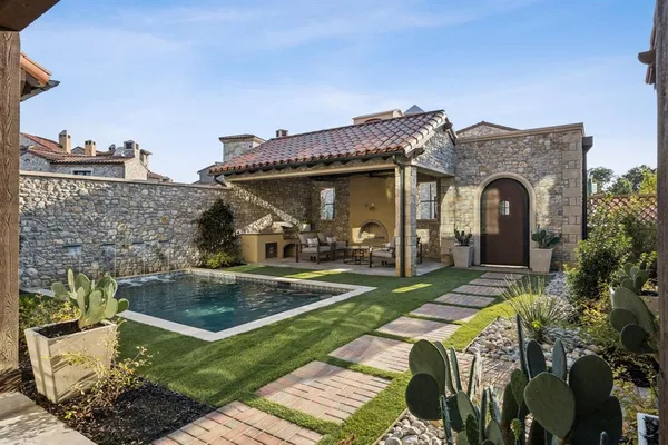 a view of a house with swimming pool and a yard