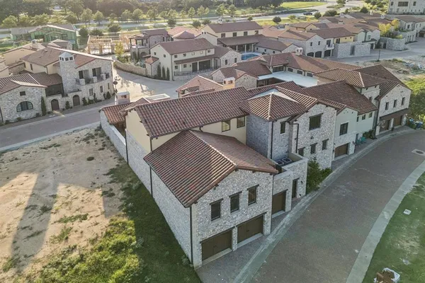 an aerial view of residential houses with outdoor space
