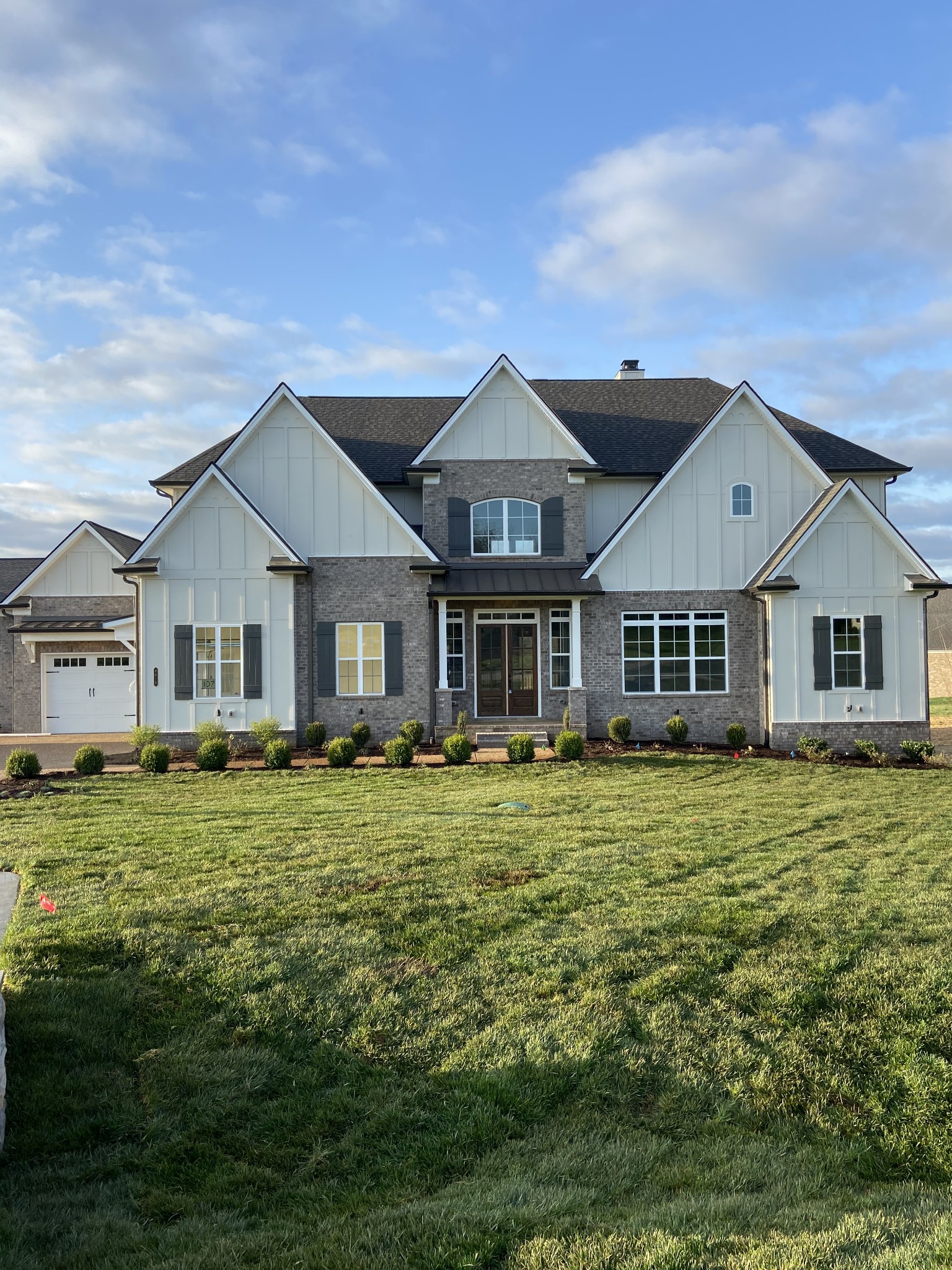 a front view of a house with a garden