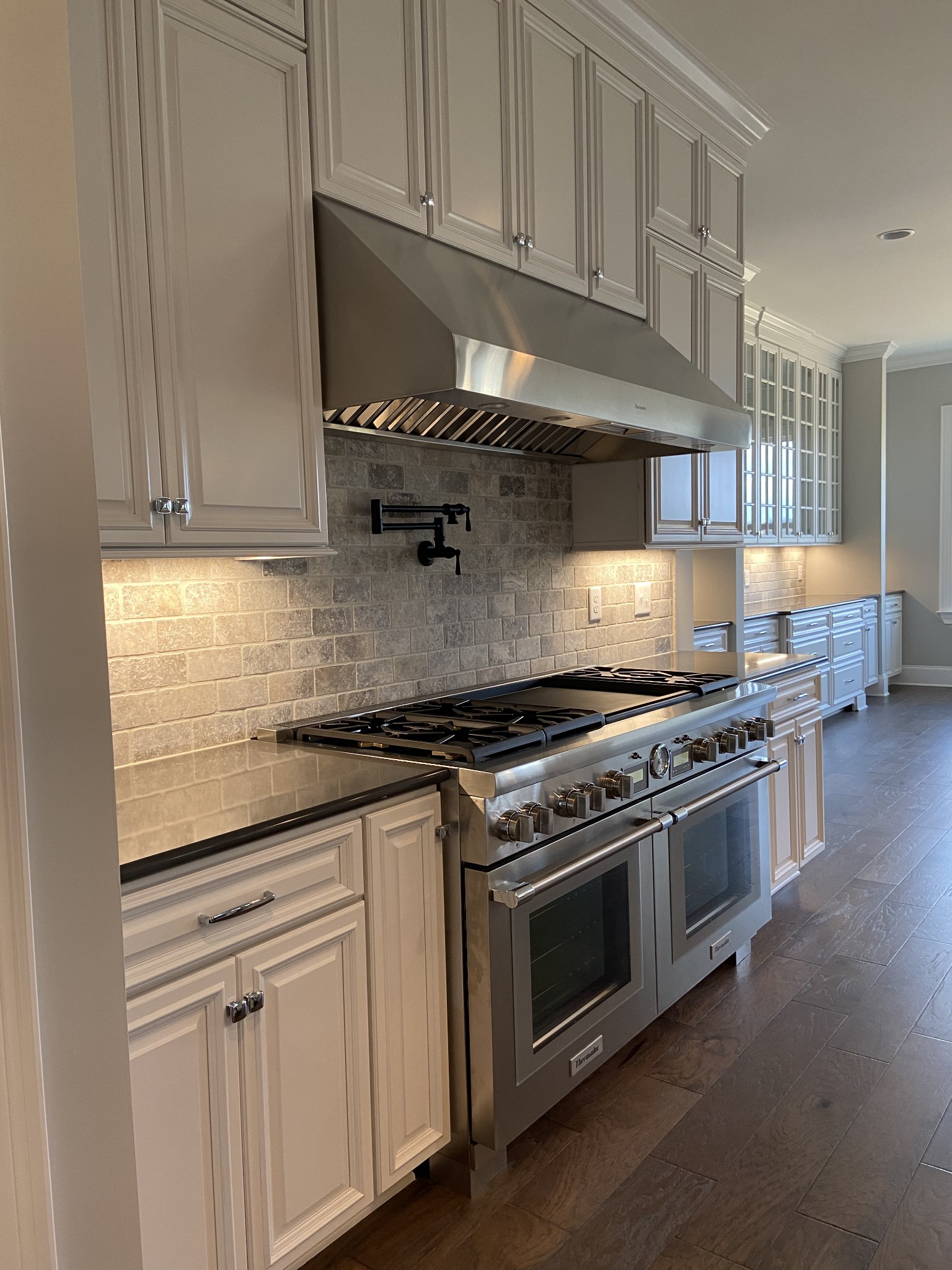 8015 Burning Tree Farms Road Arrington, TN 37014 - Photo 3 of 10 a kitchen with stainless steel appliances granite countertop a stove and a white cabinets