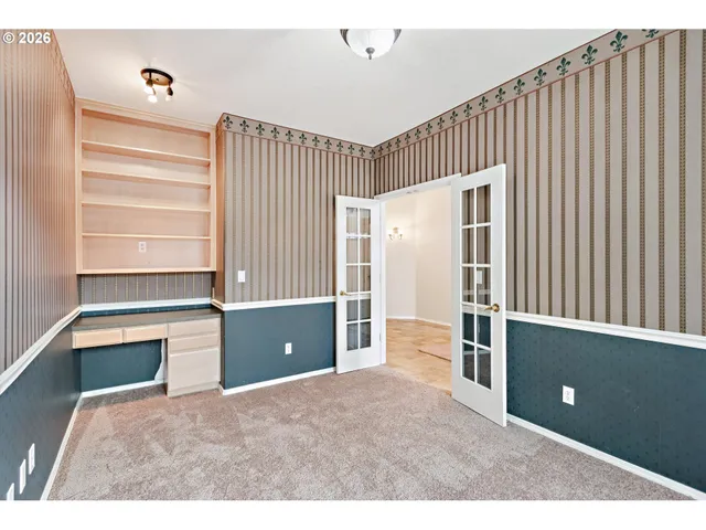 a view of an empty room with a fireplace