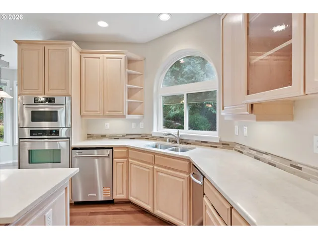 a kitchen with a sink stove and microwave