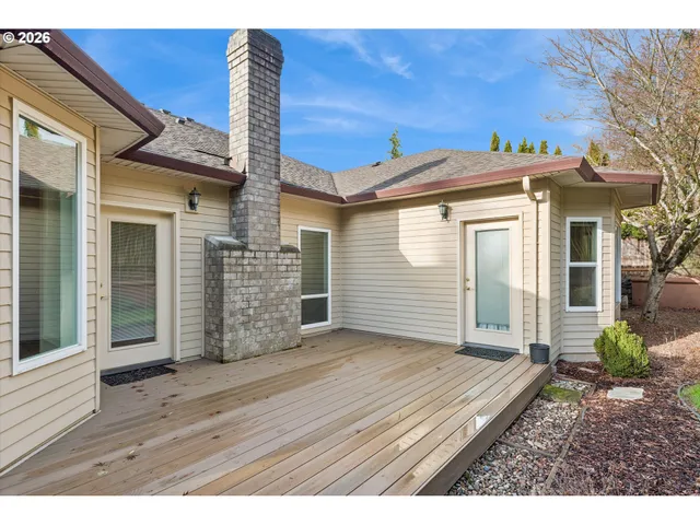 a view of a house with wooden fence