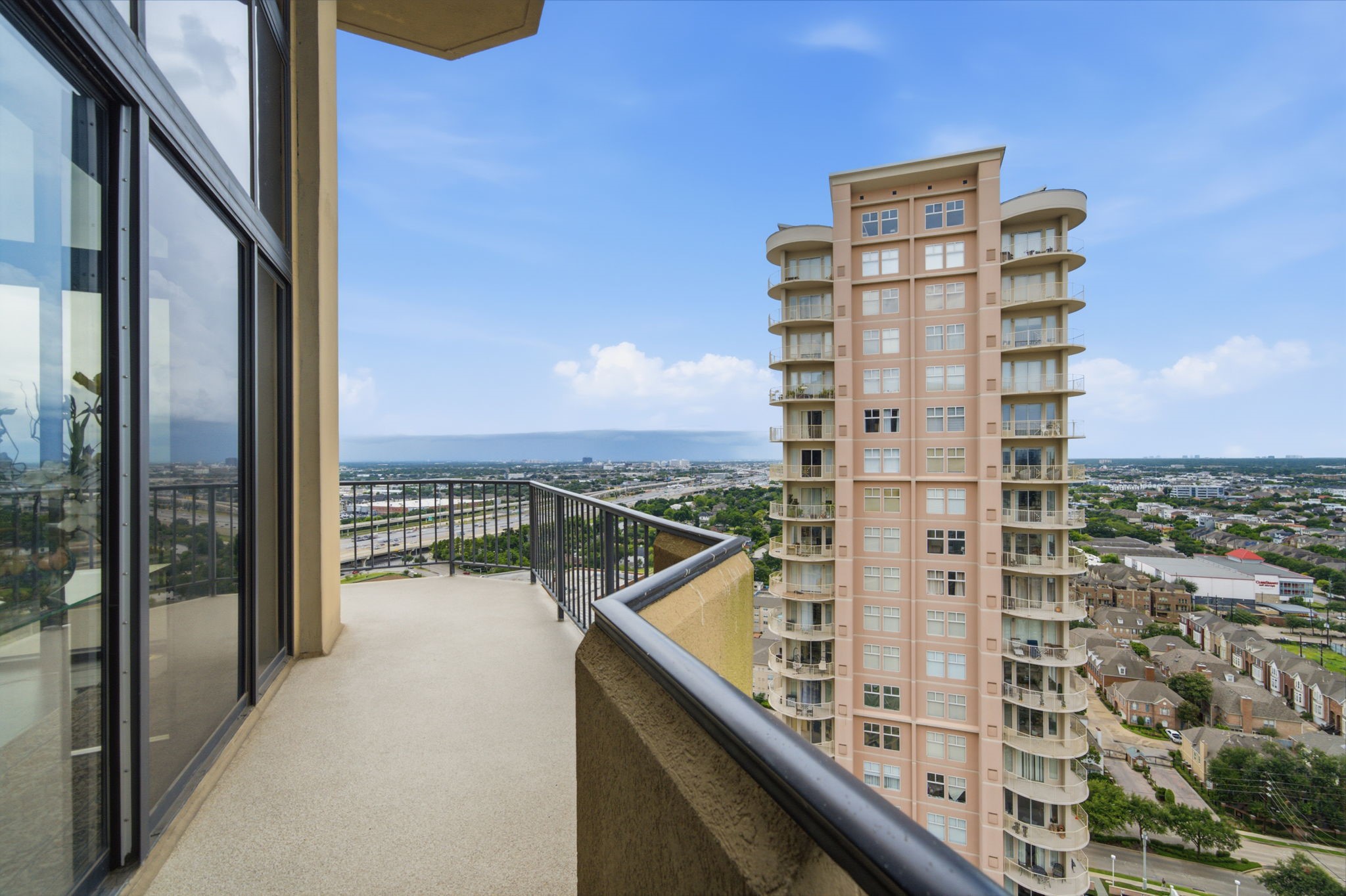 3350 McCue Road, Unit 2402 Houston, TX 77056 - Photo 39 of 49 Expansive open-air balconies offer an elevated vantage point overlooking neighboring high-rises and panoramic Houston horizon vistas. Sturdy architectural railings and direct connections to the interior create a seamless outdoor retreat for al fresco lounging above the Galleria district.