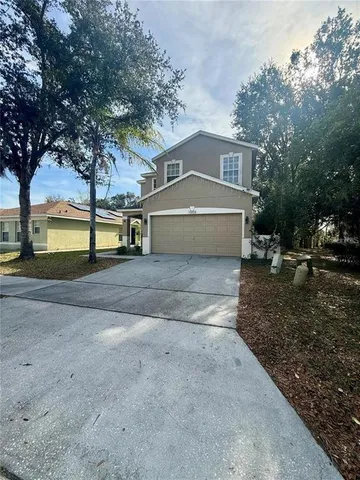 a front view of a house with a yard and garage