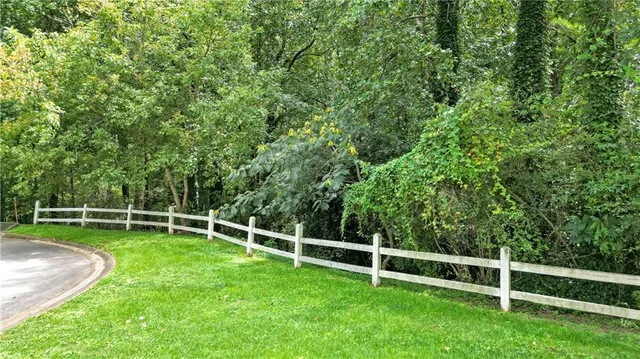 a view of a backyard with a wooden fence