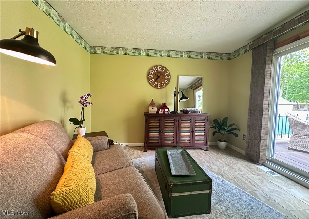 157 Birch Road Painesville, OH 44077 - Photo 12 of 41 Living area with a textured ceiling and baseboards