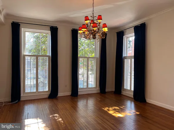 a view of a room with wooden floor and a window