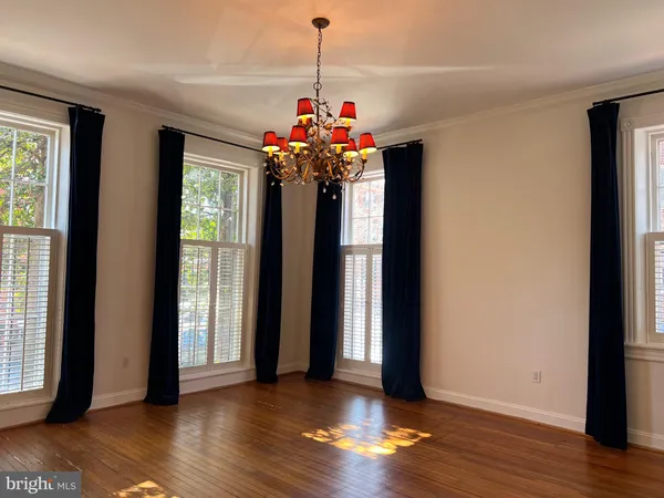a view of a room with wooden floor and a window